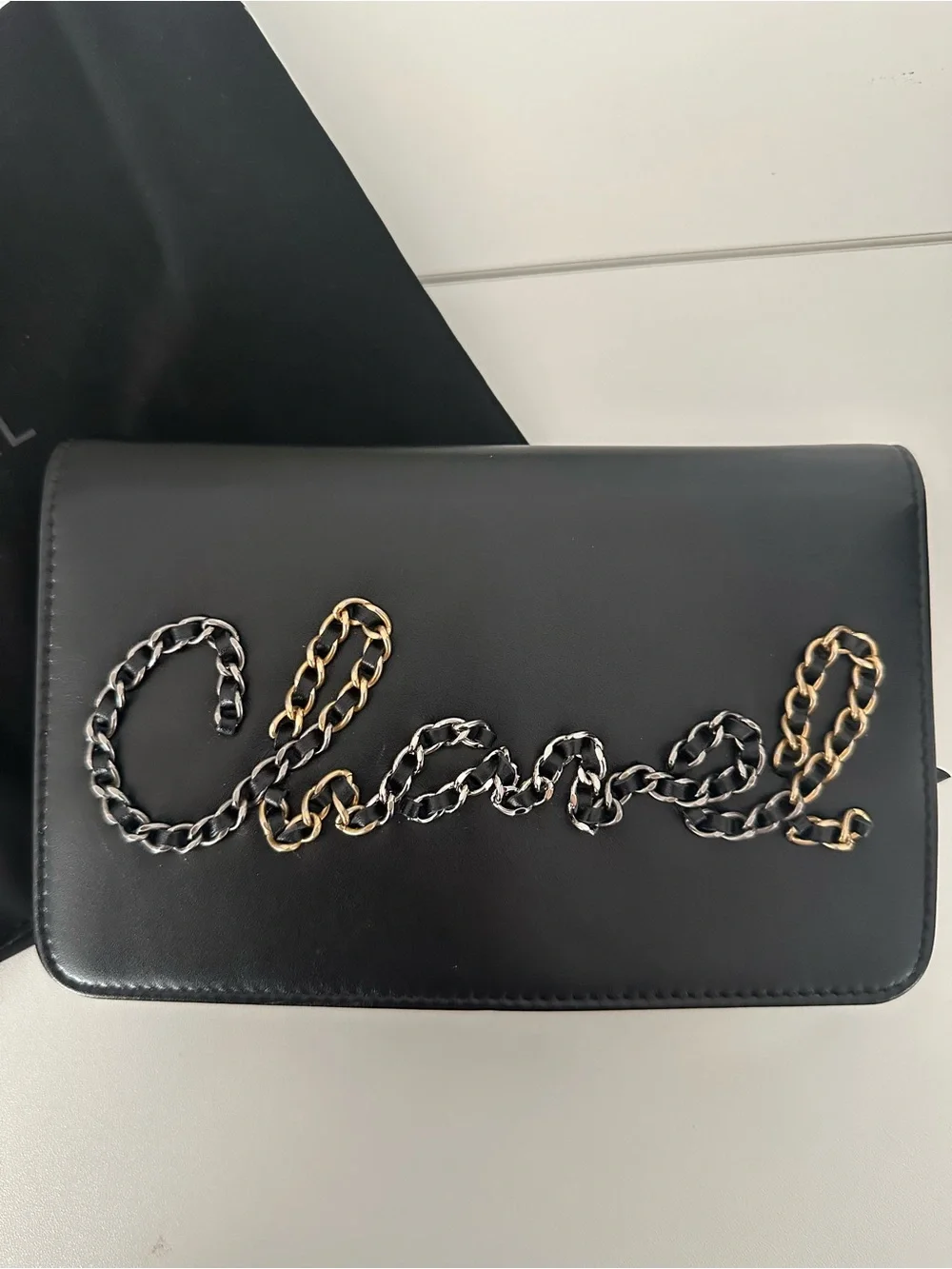 CHANEL Black Leather Clutch with Mixed Metal Chain Script